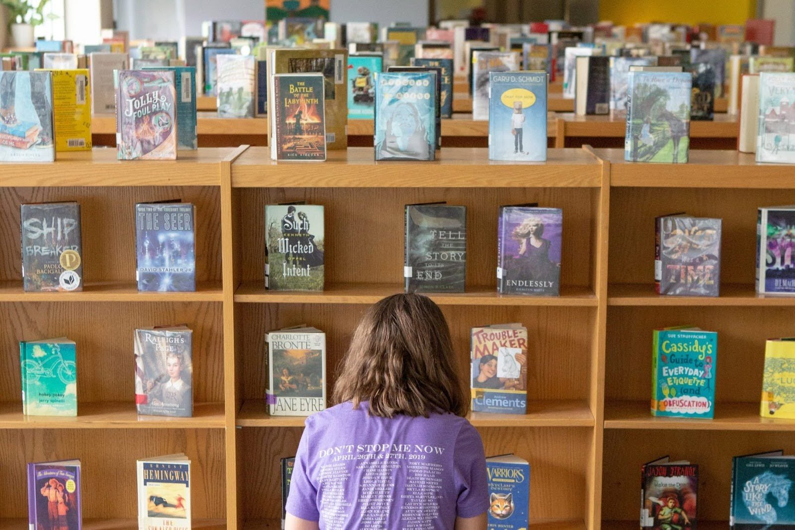 Student in front of rows of books